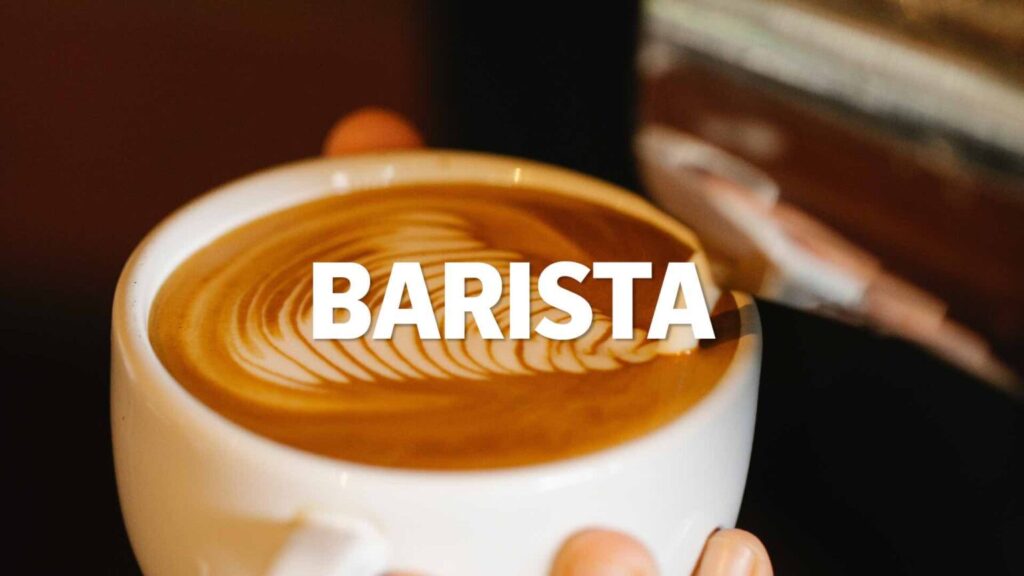 Weiße Kaffeetasse mit Latte Art und dem Text "BARISTA".