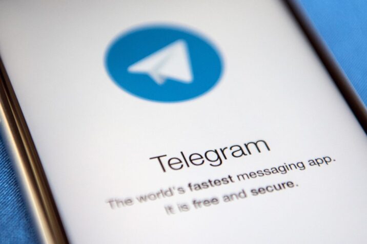 Smartphone display with Telegram app icon and text.